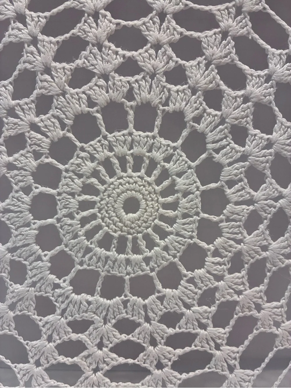 Handmade 10” crochet doily stretched inside a wooden embroidery hoop